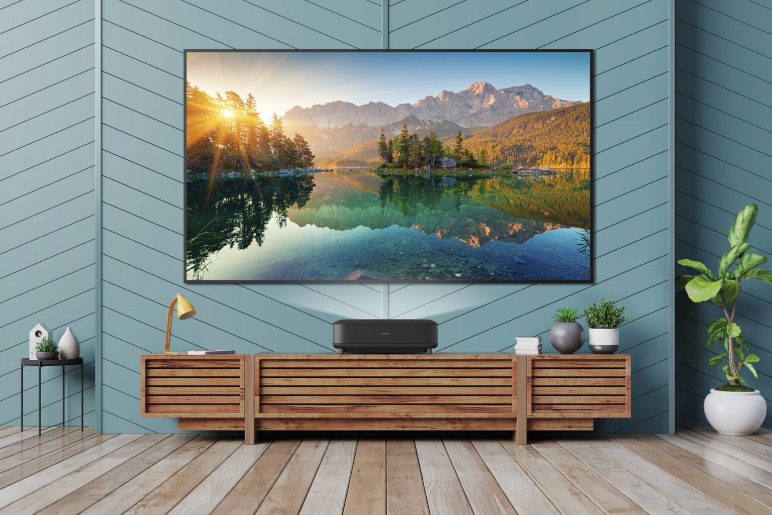 Sprawdź 3 funkcje nowego projektora marki Epson, które zamienią Twój salon w salę kinową Smart Tv mockup hanging on herringbone blue wooden wall in modern interior,3d rendering